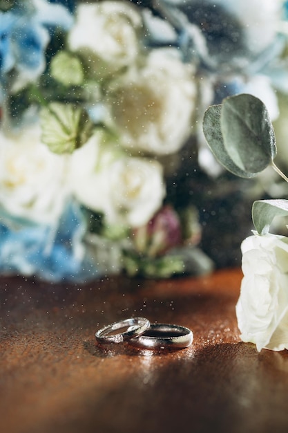 Wedding rings with flowers before the wedding ceremony