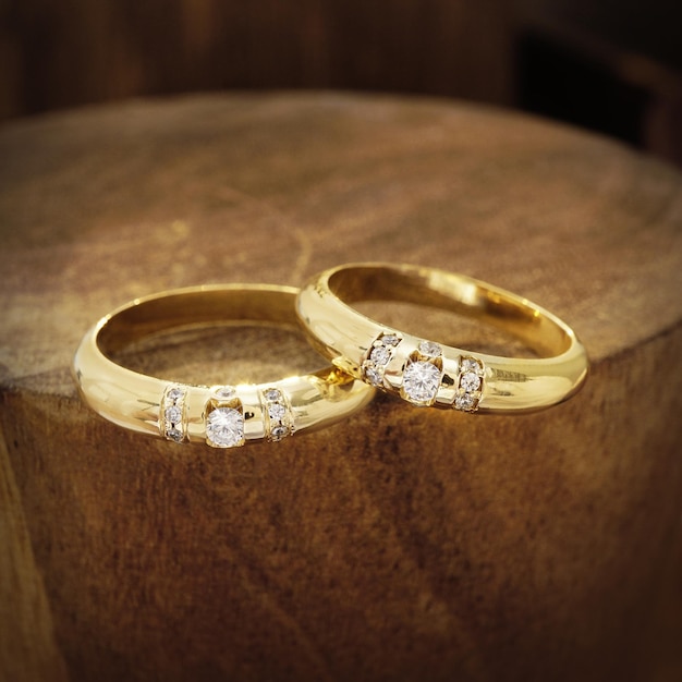 wedding rings on wooden background