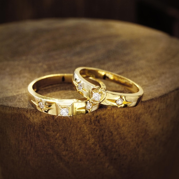 wedding rings on wooden background