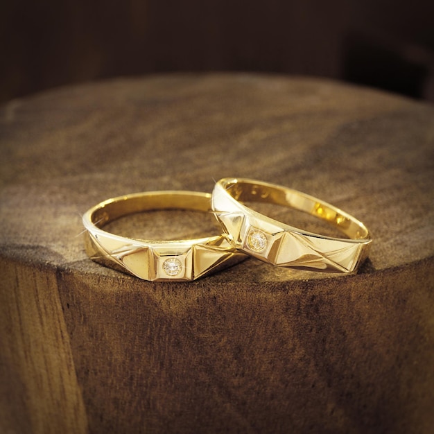 wedding rings on wooden background