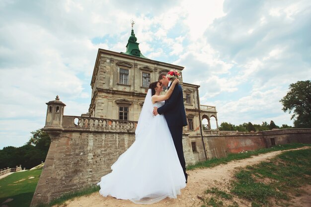 Wedding shot of bride and groom in park of castle