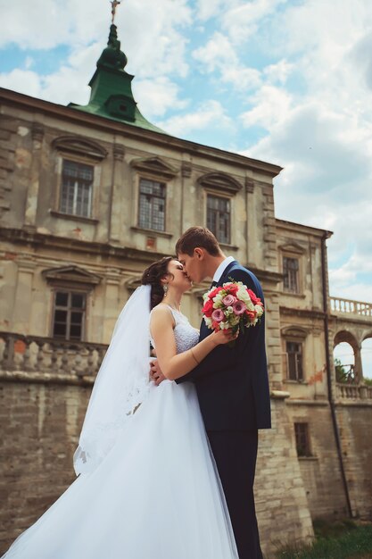 Wedding shot of bride and groom in park of castle