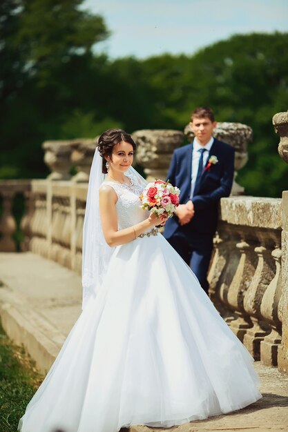 Wedding shot of bride and groom in park of castle