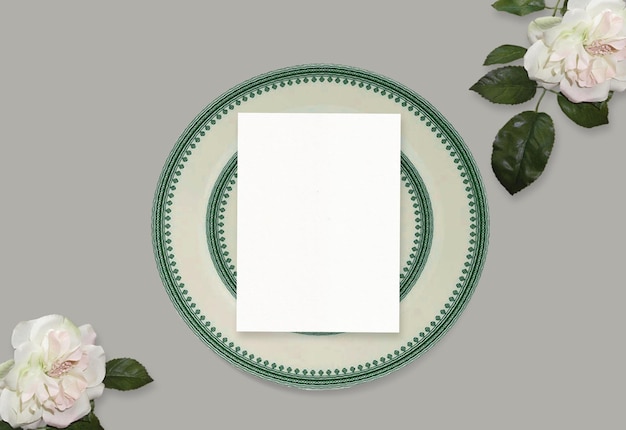 Wedding stationery mock-up scene. Blank greeting card, ceramic white and green plate