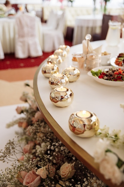 Photo wedding table decorated with beautiful candles and different colors. festive food on the table. wedding banquet.