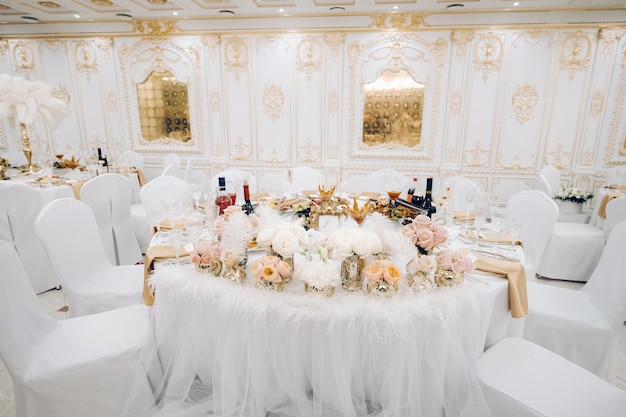 Wedding table decoration with flowers on the table in the castle