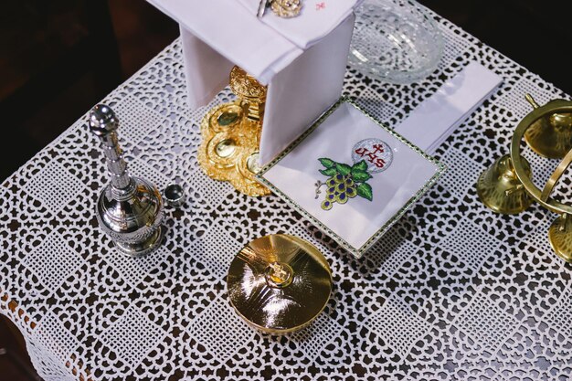 Wedding table with silver and gold candlesticks and candlesHoly communion Catholic theme