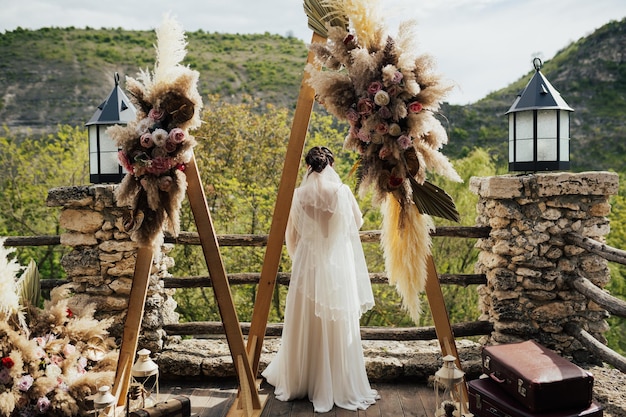 Wedding triangular wooden arch in rustic style