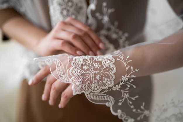 Wedding veil closeup of embroidered pattern on hand