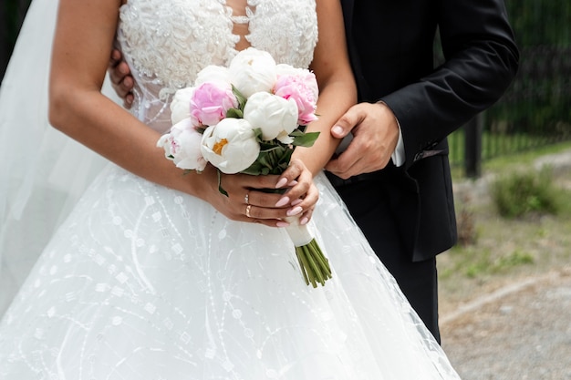 Wedding . Wedding bouquet from colorful roses in hand of the bride.