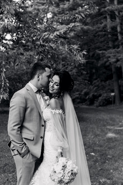 Wedding. Wedding day. Beautiful bride and elegant groom walking after wedding ceremony. Luxury bridal dress and bouquet of flowers. Bride and groom at wedding day
