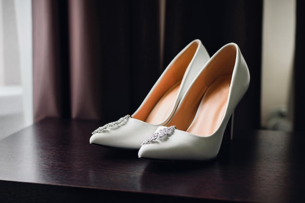 Wedding white bride shoes with silver earrings