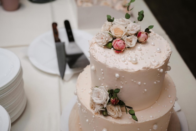 Wedding white cake with tiers decorated with rose flowers