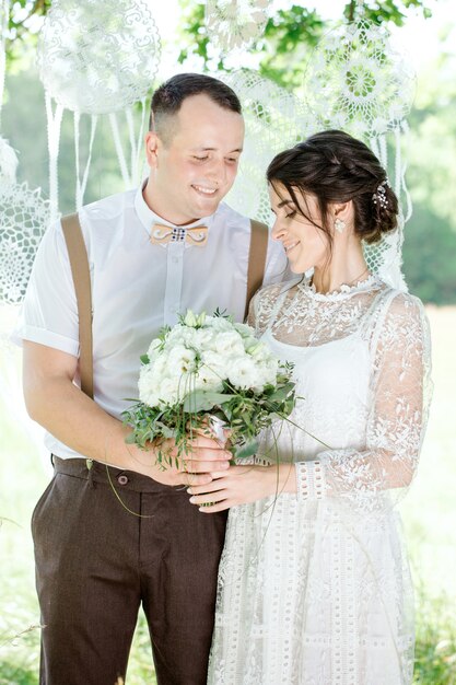 Wedding of a young beautiful couple in vintage style. Closeup portrait of a young happy newlywed couple