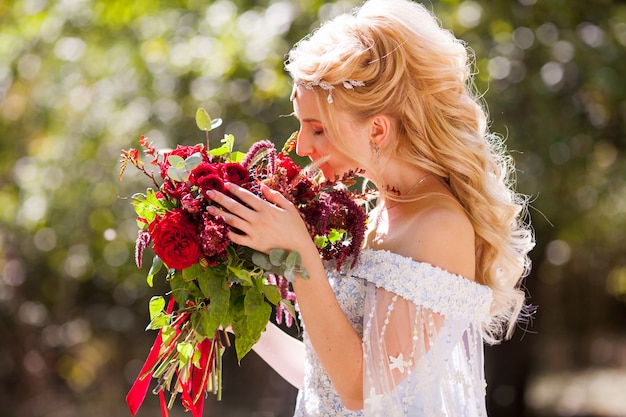 Wedding of a young couple with a walk through the green park.