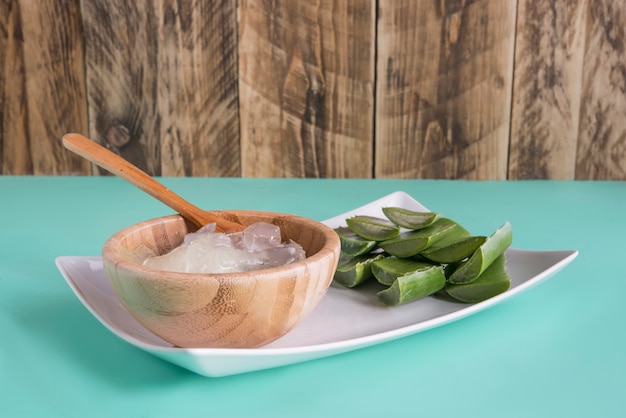 wedges of aloe vera in a wooden bowl