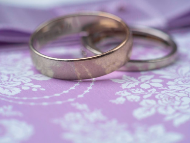 Weeding postcard with rings on purple background blurred