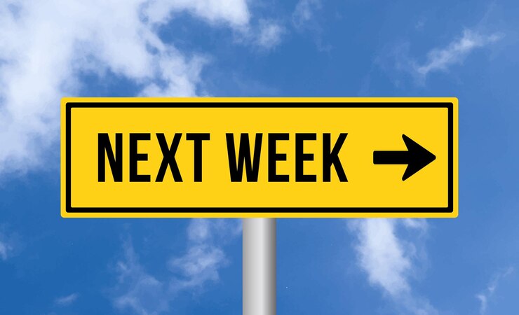 फोटो next week road sign on blue sky background