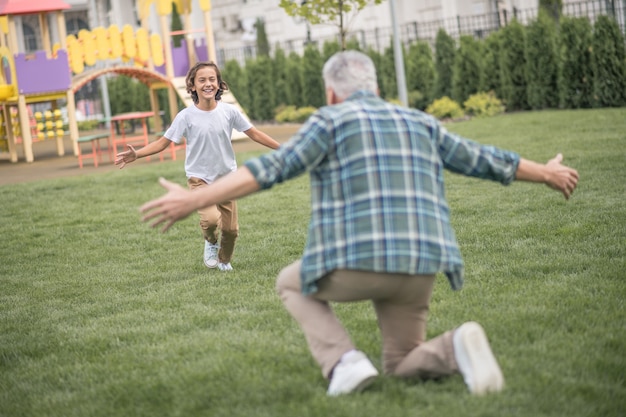 weekend dad. boy running to his dad and looking happy