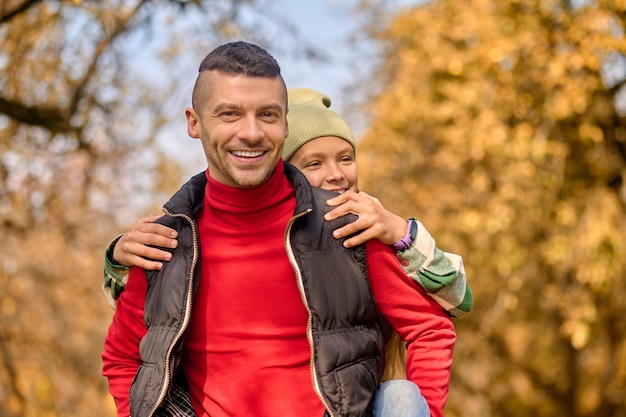 Weekend. Dad and daughter playing in the park and looking happy