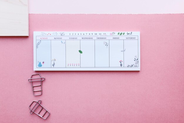 Photo weekly planner on pink background