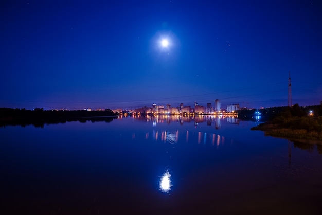 Weerspiegeling van de nachtstad op de waterspiegel