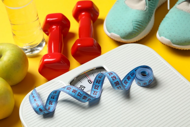 weight loss or healthy lifestyle accessories on yellow floor