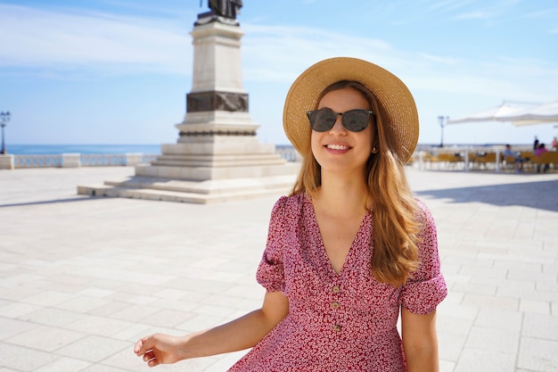 Welcome in Apulia. Portrait of pretty stylish girl smiling looking at camera in Otranto, Salento, Italy.