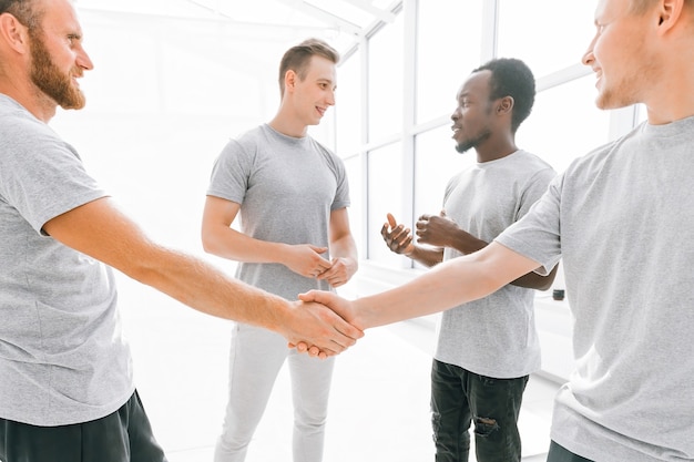 Welcome handshake of friends in a bright office