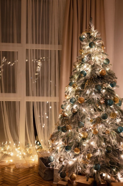 Welcome Home Christmas Tree Window with Decorated Glowing Christmas Tree inside House