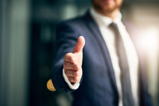 Welcome to a new opportunity Cropped shot of an unrecognizable businessman extending a handshake in an office