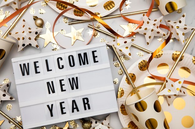 Welcome new year lightbox celebration message with luxury gold party decorations