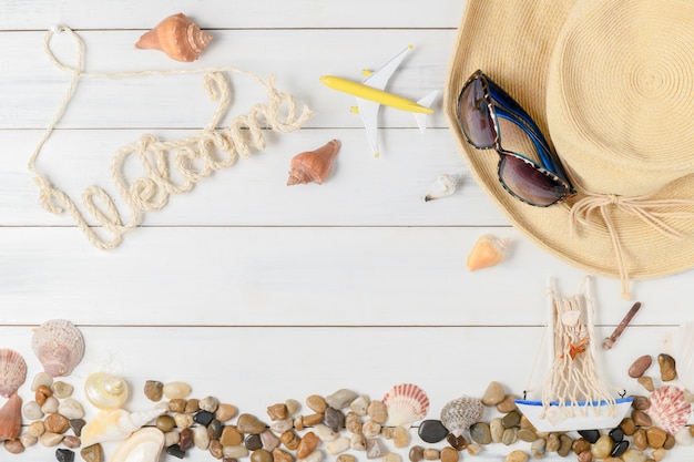 Welcome text with summer accessories, sandals and shell 