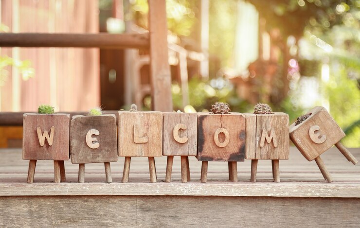 Photo welcome word on wooden table in home 
