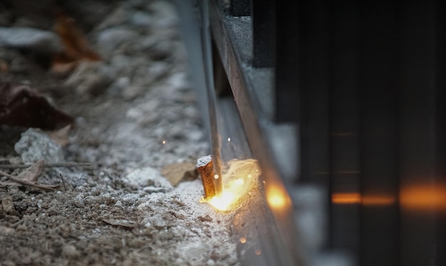 welder is welding metal part on a construction site