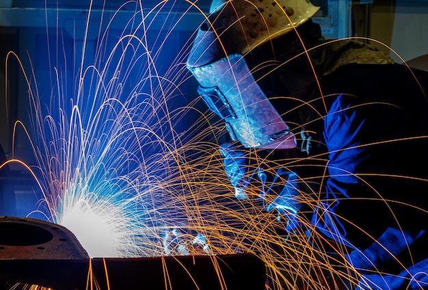 The welder is welding steel plates