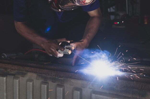 Welder welding automotive part in a car factory