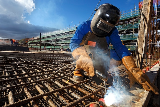 Welder welding iron beams for civil construction