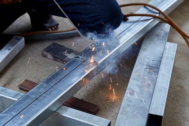 The welders are welding steel in the factory