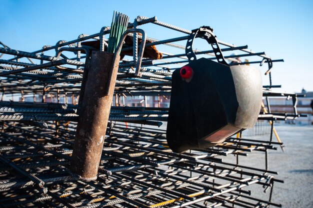 the welders mask lies on a metal armature in closeup