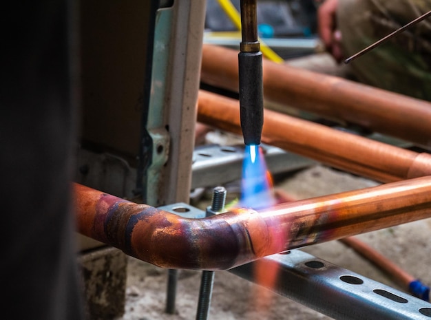 Photo welding copper pipes closeup