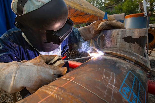 Welding male worker metal is part in machinery nozzle pipeline construction petroleum oil and gas