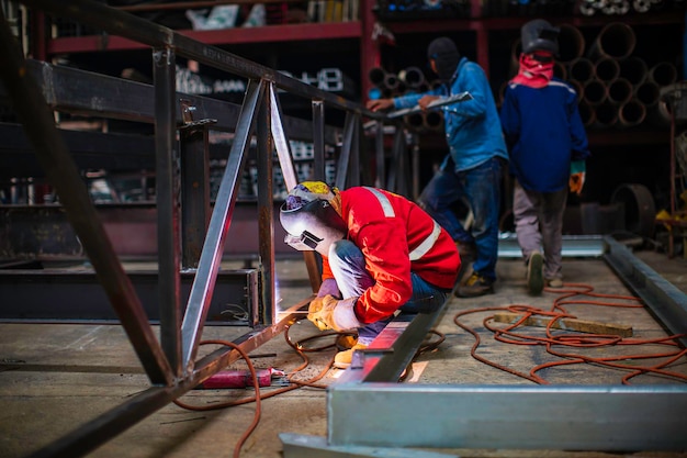 Welding male worker metal steel is part of beam structure