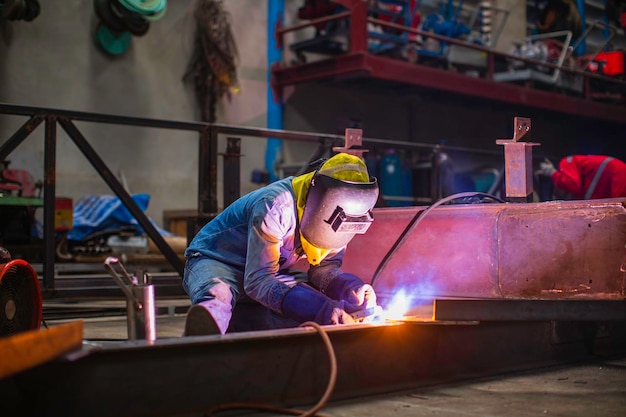 Welding male worker metal steel is part of beam structure