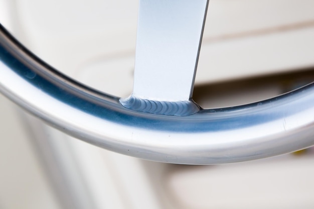 Photo welding seam on the stainless steering wheel of an expensive motor yacht