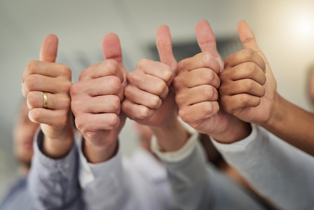 Well done on your win Cropped shot of a group of businesspeople giving thumbs up in a modern office