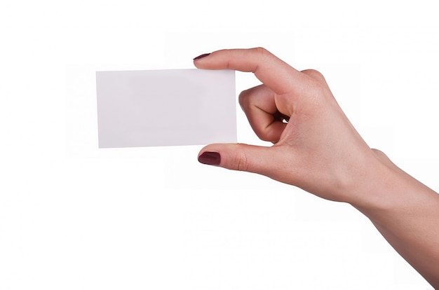 Well-groomed female hand with manicure and red lacquer holding an empty white card