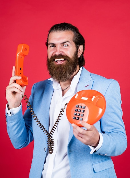 Well groomed man in wedding formalwear has beard use retro phone call