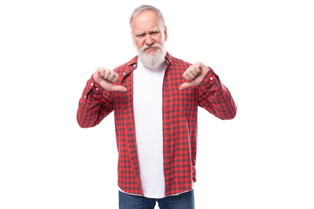 Wellgroomed with an elderly grandfather a man with a gray beard shows his hands to himself