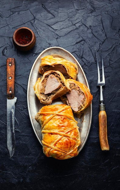 Wellington pork pork tenderloin baked with mushrooms in puff pastry